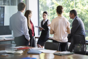 Businesswoman discussing with colleagues in office